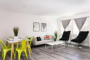 a living room with a table and yellow chairs at Central 3BR Apt Near Americana in Glendale