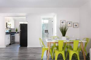 a dining room with a table and yellow chairs at Central 3BR Apt Near Americana in Glendale