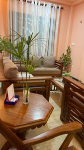 a living room with a couch and a table with a plant at Grand Villa - Gonapinuwala,Hikkaduwa in Gonapinuwala West