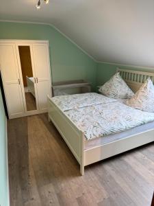 a bedroom with a bed and a mirror at Eifelnest Stadtkyll in Stadtkyll