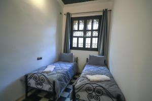 Ένα ή περισσότερα κρεβάτια σε δωμάτιο στο Riad dar Saham