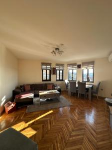 a living room with a couch and a table at Apartment Zdravets, in the heart of the old city in Veliko Tŭrnovo +28 photos