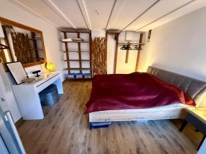 a bedroom with a bed and a desk in a room at Lahn-Paradies  +12 photos