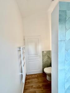 a bathroom with a toilet and a glass door at Nana Bloo in La Teste-de-Buch +30 photos