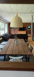 a large wooden table in a living room with a ceiling at A terraced house by the river! 
