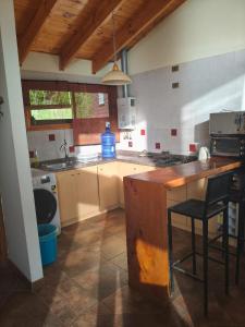 a kitchen with a counter and a stove top oven at Cabaña en cahuil pichulemu in Cáhuil