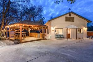 a building with a gazebo and a church at Sunset Retreat- TWO houses with hot tub, firepit, multiple kitchens, sleeps 20! in Oakhurst