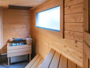 a cabin with a window and a wooden wall at Aquapark Bel Mare F429 in Międzyzdroje