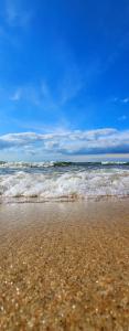 a sandy beach with waves in the ocean at Aquapark Bel Mare F429 in Międzyzdroje +29 photos