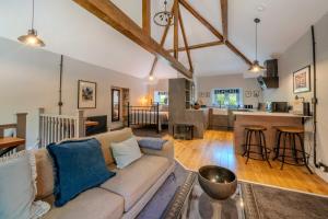 a living room with a couch and a kitchen at Goytre Hall Self Catering Guest Accommodation in Abergavenny