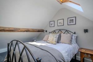 a bedroom with a bed in a attic at Goytre Hall Self Catering Guest Accommodation in Abergavenny