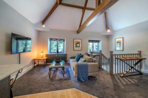 a living room with a couch and a table at Goytre Hall Self Catering Guest Accommodation in Abergavenny