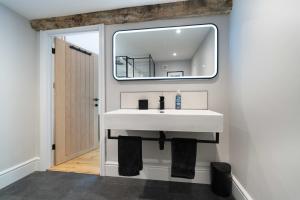 a bathroom with a white sink and a mirror at Goytre Hall Self Catering Guest Accommodation in Abergavenny +37 photos