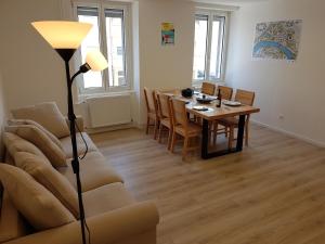 a living room with a couch and a table at Maison Vauban in Huningue