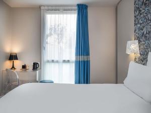Ένα ή περισσότερα κρεβάτια σε δωμάτιο στο Mercure Le Mans Batignolles - Hotel & Spa