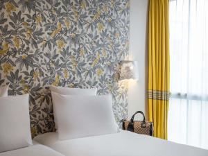 Ένα ή περισσότερα κρεβάτια σε δωμάτιο στο Mercure Le Mans Batignolles - Hotel & Spa
