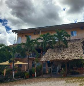 a building with palm trees in front of it at Rolson Hotel in San Ignacio