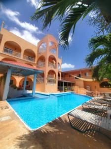 a swimming pool in front of a building at Rolson Hotel in San Ignacio