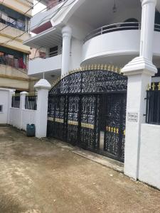 a black gate on the side of a white building at 4 Bedroom Luxury House in Patantulla Sylhet in Sylhet