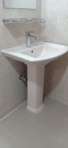 a white sink in a bathroom with a mirror at 4 Bedroom Luxury House in Patantulla Sylhet in Sylhet +10 photos