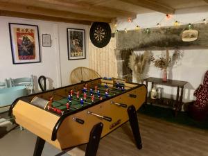 a ping pong table in a living room with at Charmante maison au coeur d'un village auvergnat in Saint-Diéry