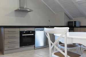 a kitchen with a white counter top and a white dishwasher at El Molino de Pochas in Bielsa