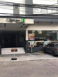 Ein Auto parkt auf einem Parkplatz vor einem Geschäft in der Unterkunft Explorer Suite 1004 in Bacolod City