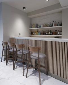 a group of chairs sitting at a bar in a restaurant at New York Hotel Yerevan in Yerevan