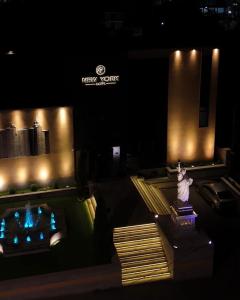 a view of a building at night with a statue at New York Hotel Yerevan in Yerevan