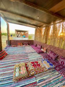 a group of pillows sitting on the floor of a tent at كامب واحة الغروب in Dār as Salām +13 photos