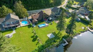an aerial view of a house with a swimming pool at Peaceful Retreat on Lac de l'Argile in Notre-Dame-de-la-Salette