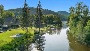 a view of a river with houses and trees at Peaceful Retreat on Lac de l'Argile in Notre-Dame-de-la-Salette