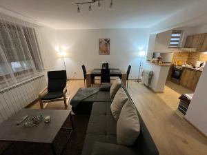 a living room with a couch and a table at Countryside rest house in Novi Banovci