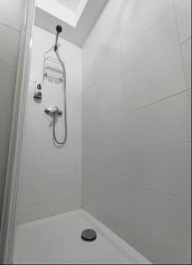 a shower in a white bathroom with a shower at Paniquera in Andorra la Vella
