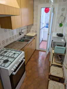 a kitchen with a stove and a sink at Apartment near Fira Barcelona, Camp Nou, and the center of Barcelona in Hospitalet de Llobregat +14 photos