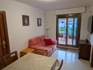 a living room with a couch and a table at Apartment near Fira Barcelona, Camp Nou, and the center of Barcelona in Hospitalet de Llobregat