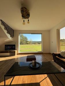 a living room with a couch and a large window at Villa Marija in Livno