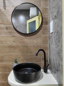 a bathroom with a black sink and a mirror at Casa Nova in Ribeira Grande +11 photos
