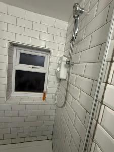 a bathroom with a shower and a window at Spacious Stay in the Heart of the Town in Moffat
