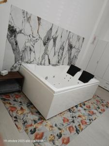 a white bath tub sitting on a rug in a bathroom at casa colombo in Balestrate