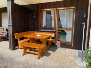 a wooden table and benches on a patio at Ferienwohnung Steibis / Allgäu in Steibis