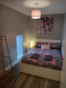 a bedroom with a bed and a painting on the wall at New Cosy three bedroom house in Ballingarry Limerick Near Adare in Limerick