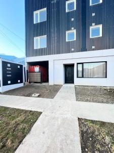 a large building with a door in front of it at Alvarez Apart in Ushuaia