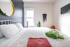 a bedroom with a large white bed with a mirror at Prime Location Top Rated Clean Parking Free! in Chillicothe