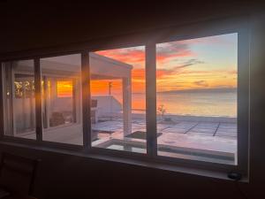 a window with a view of the ocean and the sunset at Casa Di george in Port Vila