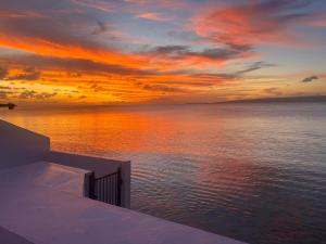 a sunset over a body of water with the ocean at Casa Di george in Port Vila +3 photos
