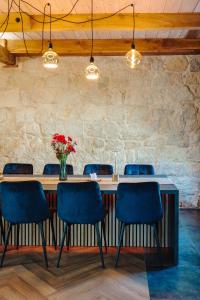 a table with chairs and a vase of flowers at Nolcken Lagerhaus in Kuressaare