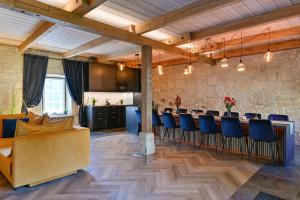 a room with a bar with chairs and a kitchen at Nolcken Lagerhaus in Kuressaare