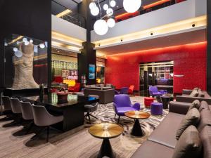 a lobby of a store with purple chairs and tables at Grand Mercure Shanghai Century Park- Free Shuttle Bus to SNIEC in Shanghai