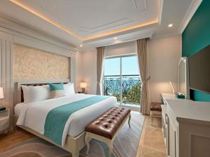 a bedroom with a large bed and a window at Mercure Nha Trang Beach in Nha Trang